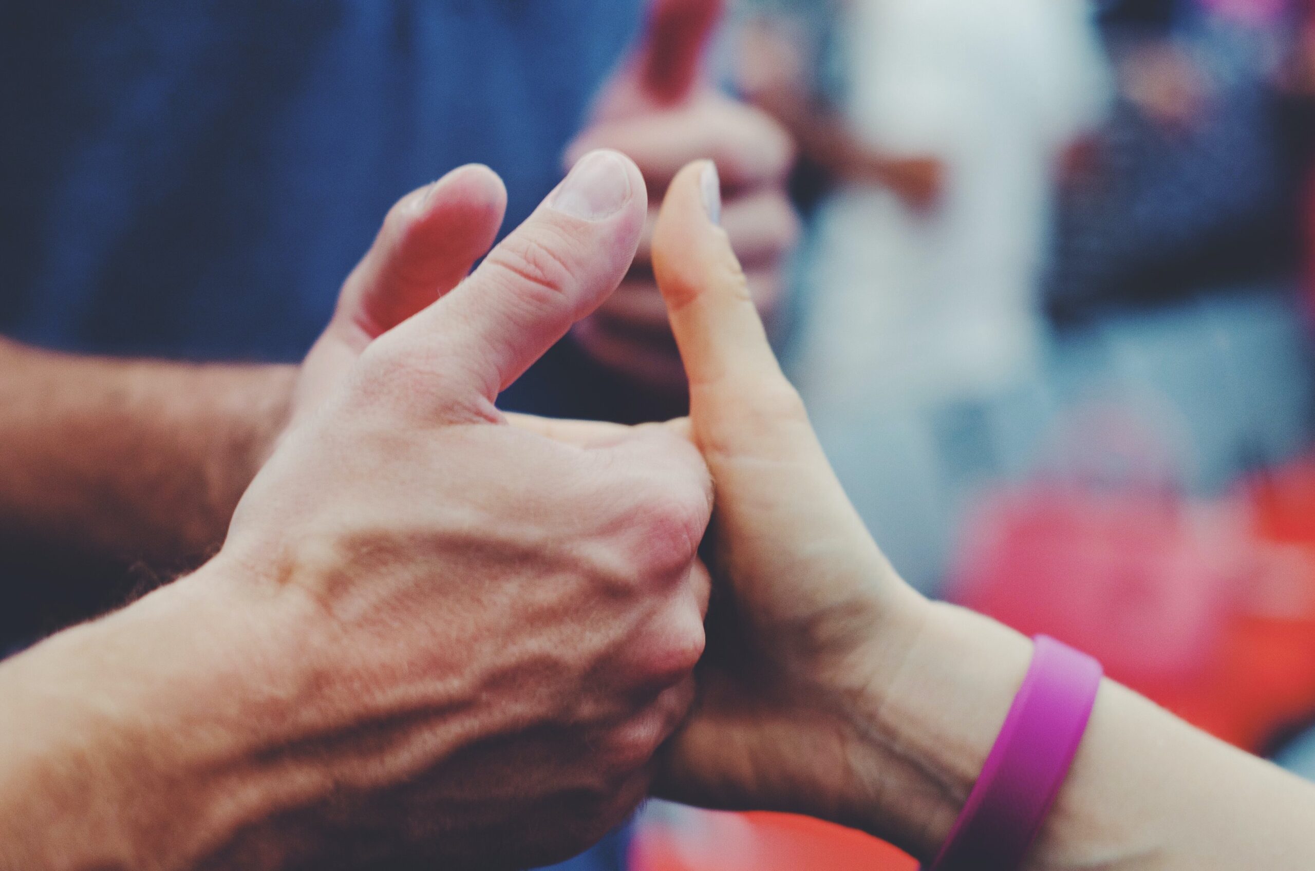 People holding hands, importance of empathy in the workplace. Mindletic blog.