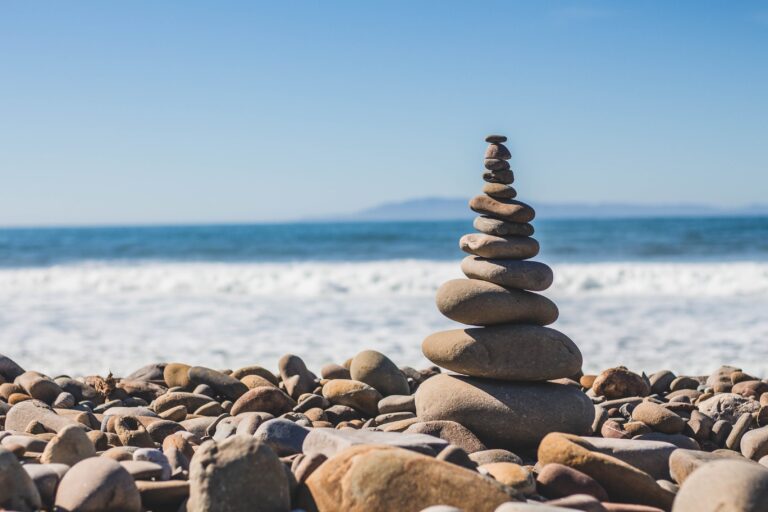 Stones put top on each other at beach. Work-life balance. Mindeltic Blog