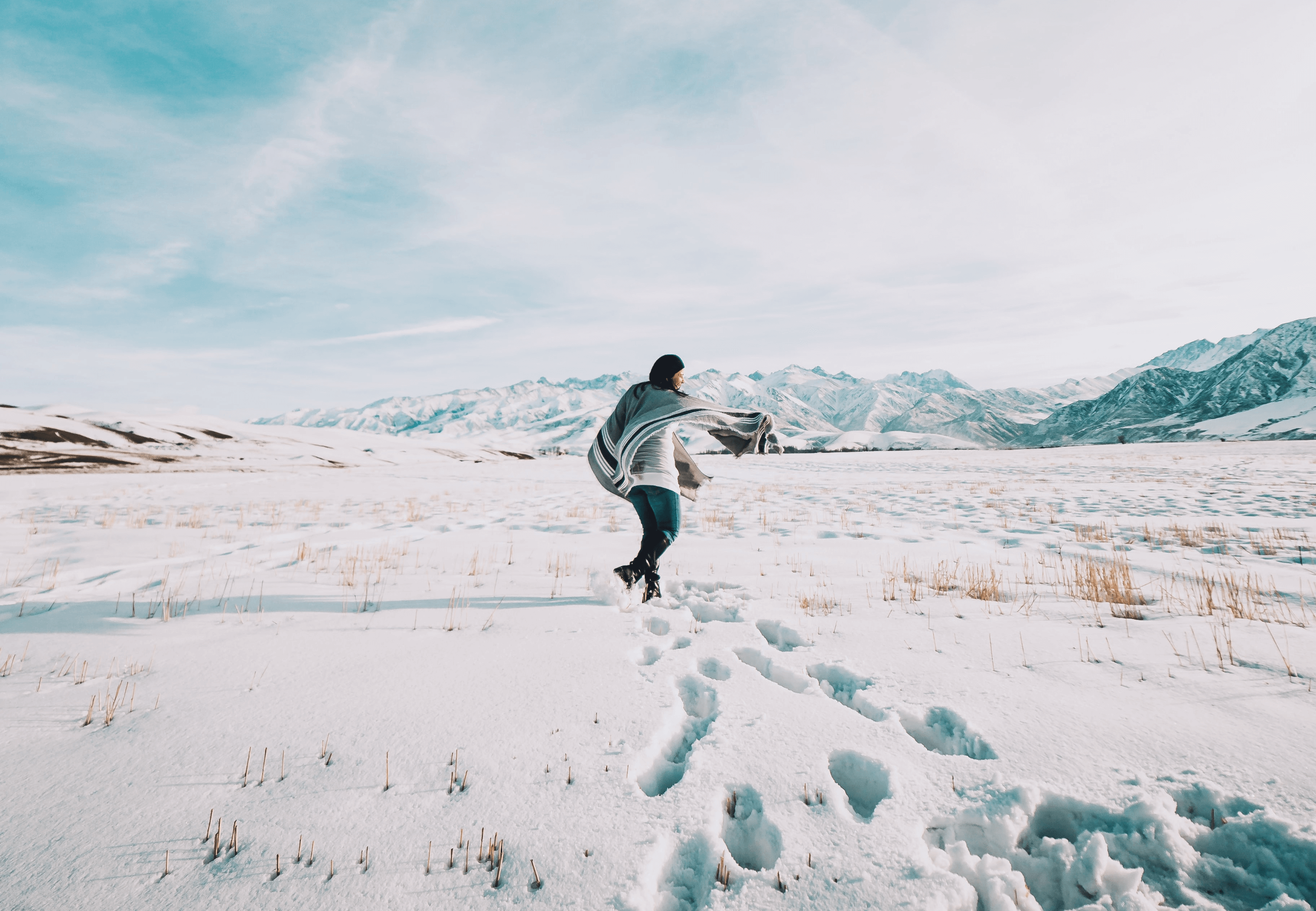 Image of woman walking in winter time, managing holiday stress. Mindletic blog.