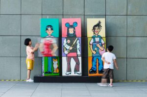Two kids near the colorful wall