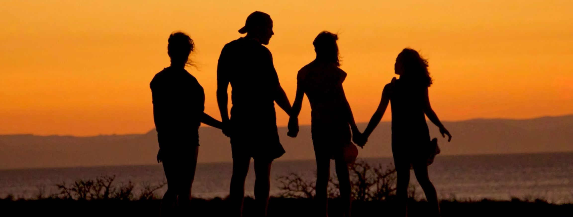 happy family enjoying sunset and talking about mental health